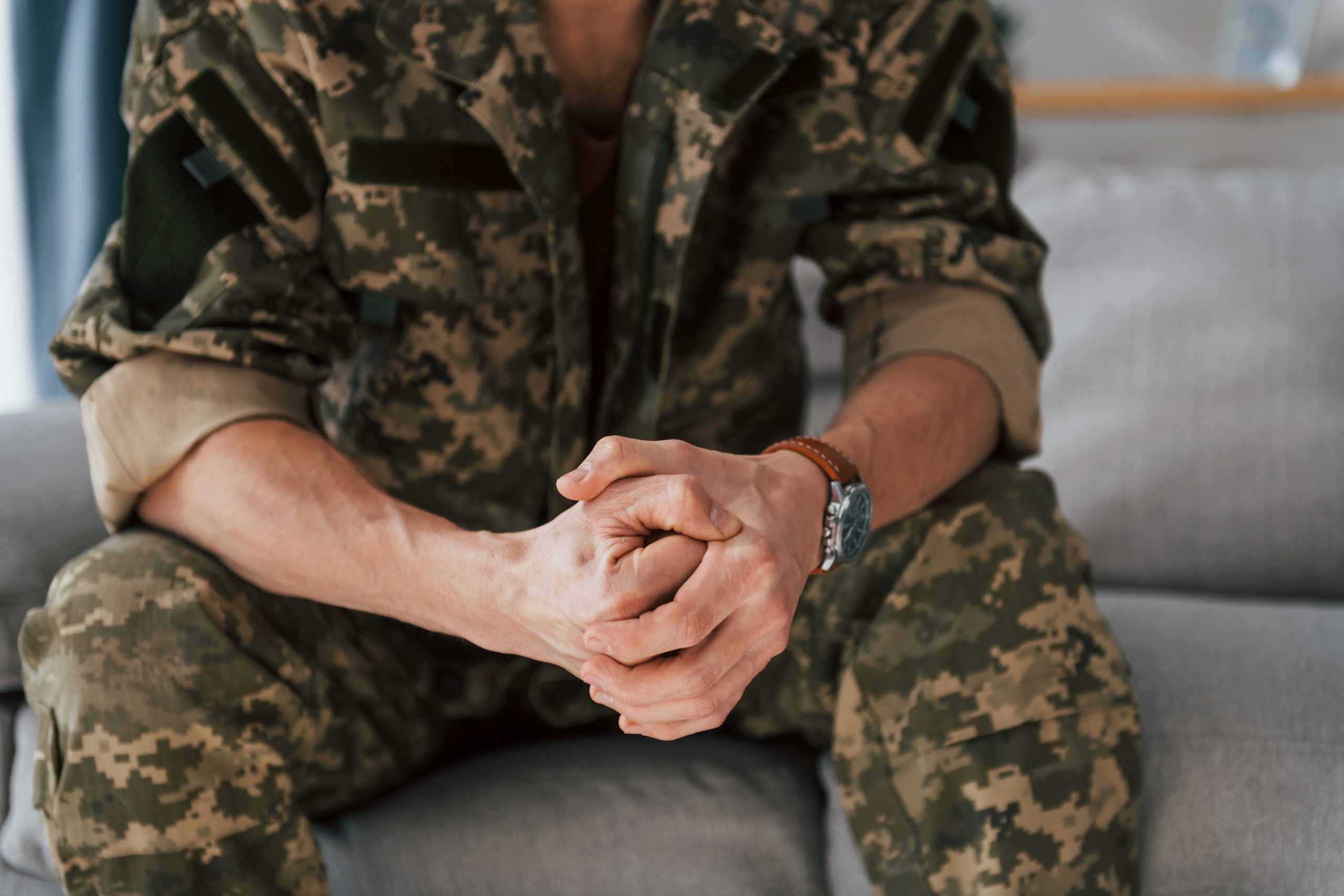 military man sitting on the couch in uniform