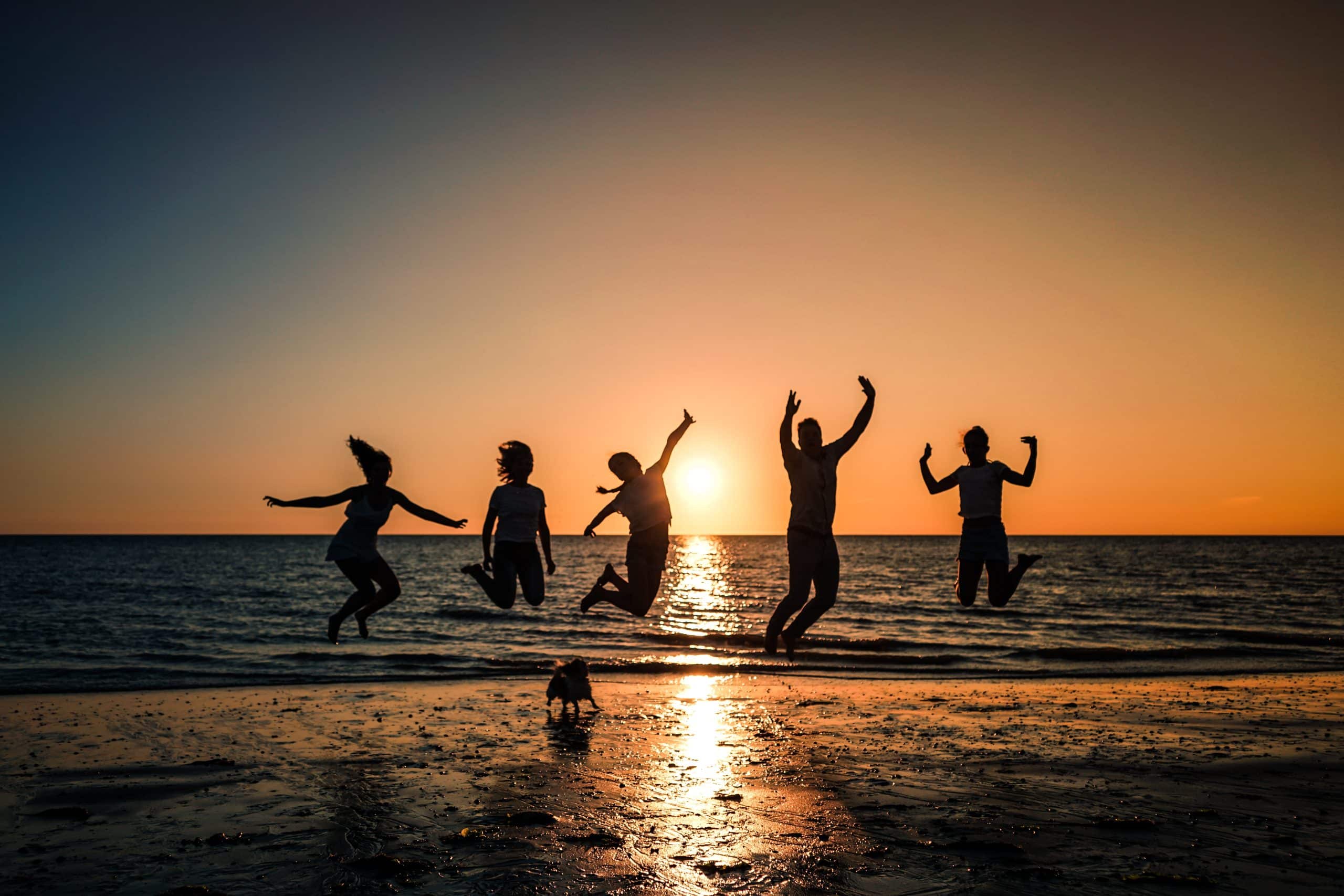 Happy group of friends jumping in west palm beach, FL, transformed lives following drug and alcohol rehab
