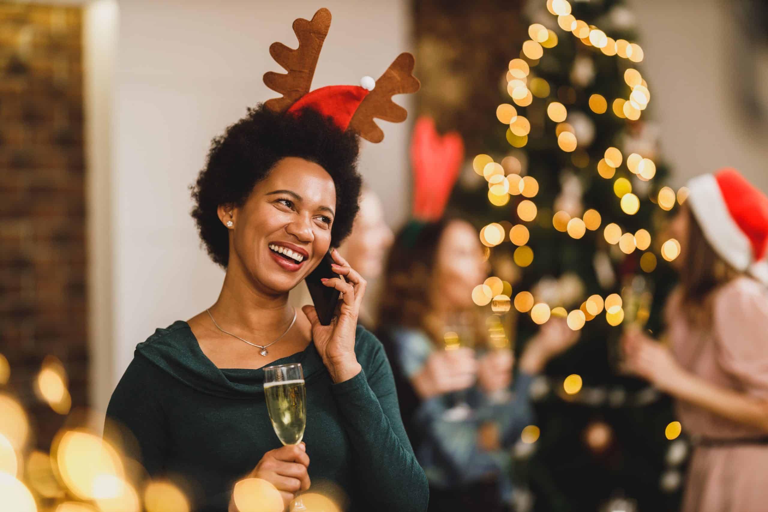 woman enjoying holiday festivities drinking alcohol, holiday drinking at party