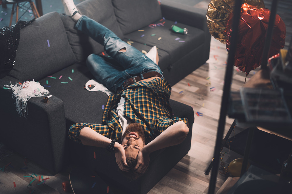 man experiencing alcohol and drug crises from summer party