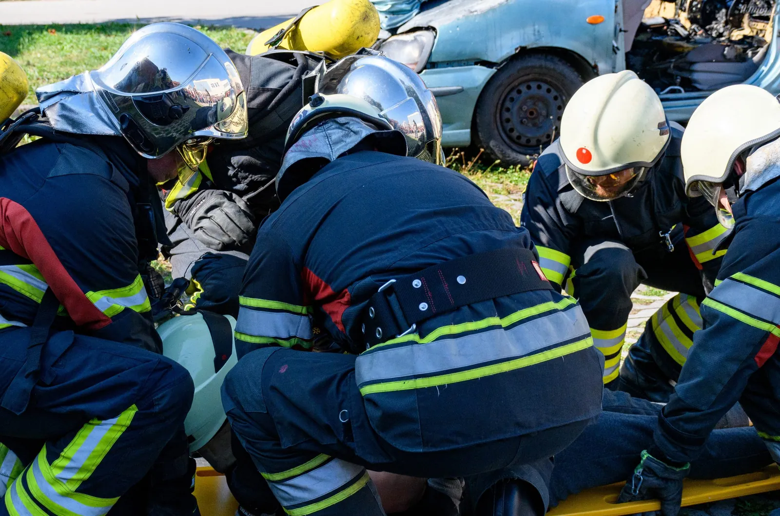 group of firemen surrounding person on stretcher group of firemen surrounding person on stretcher