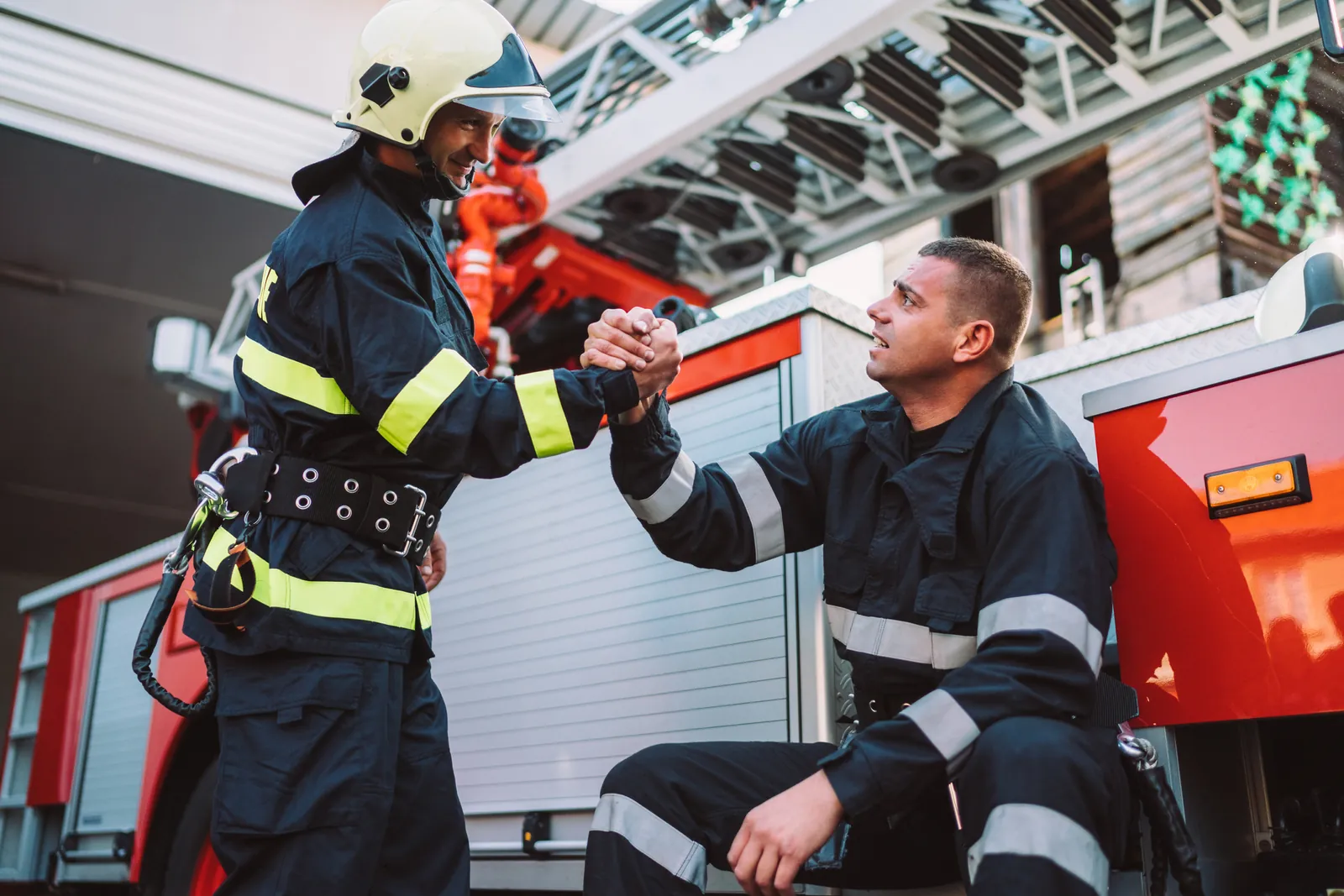 two first responders smiling and showing support for one another