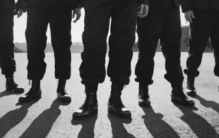 cut-off view of a group of military men in uniform
